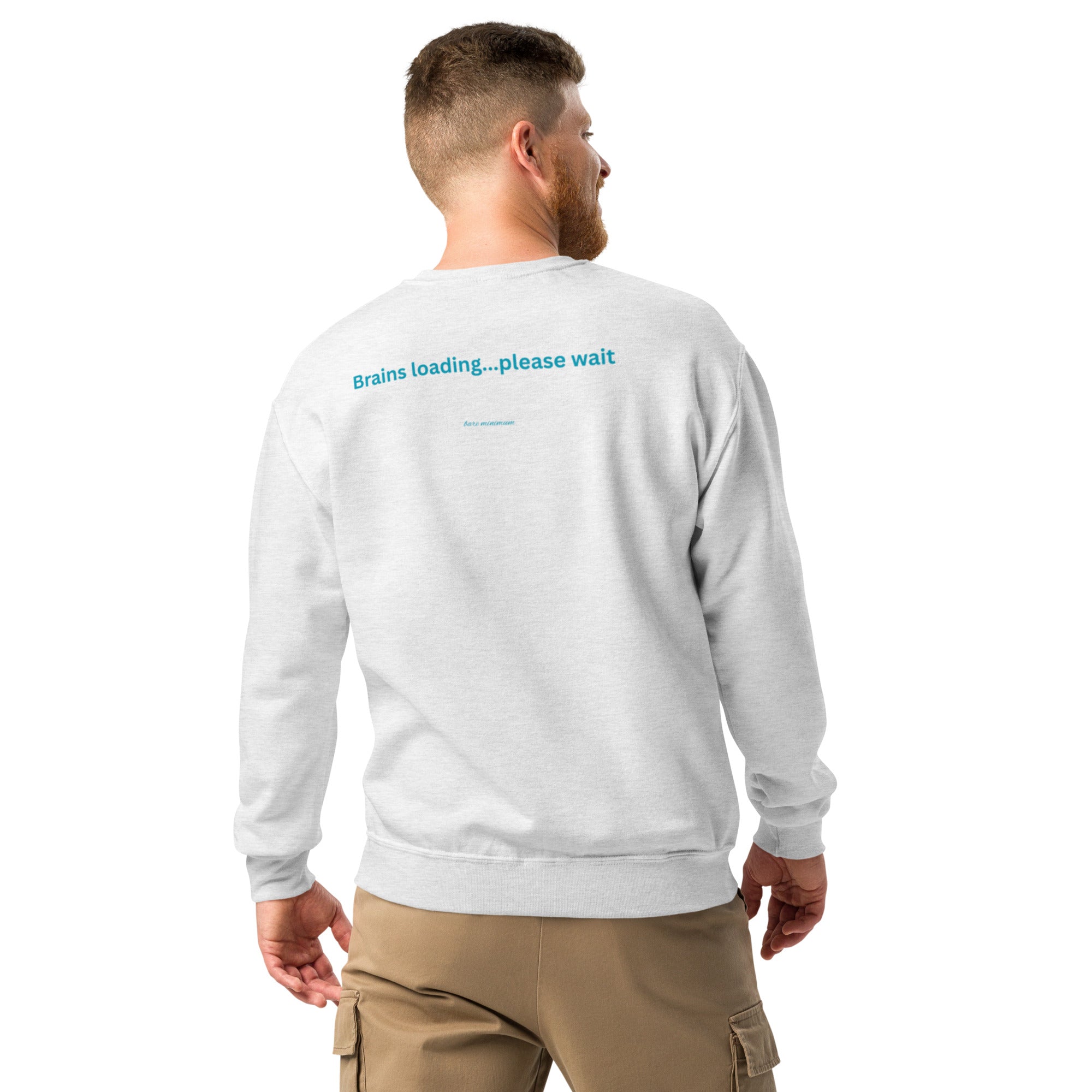 Man wearing a light gray sweatshirt with text on the back, standing against a white background