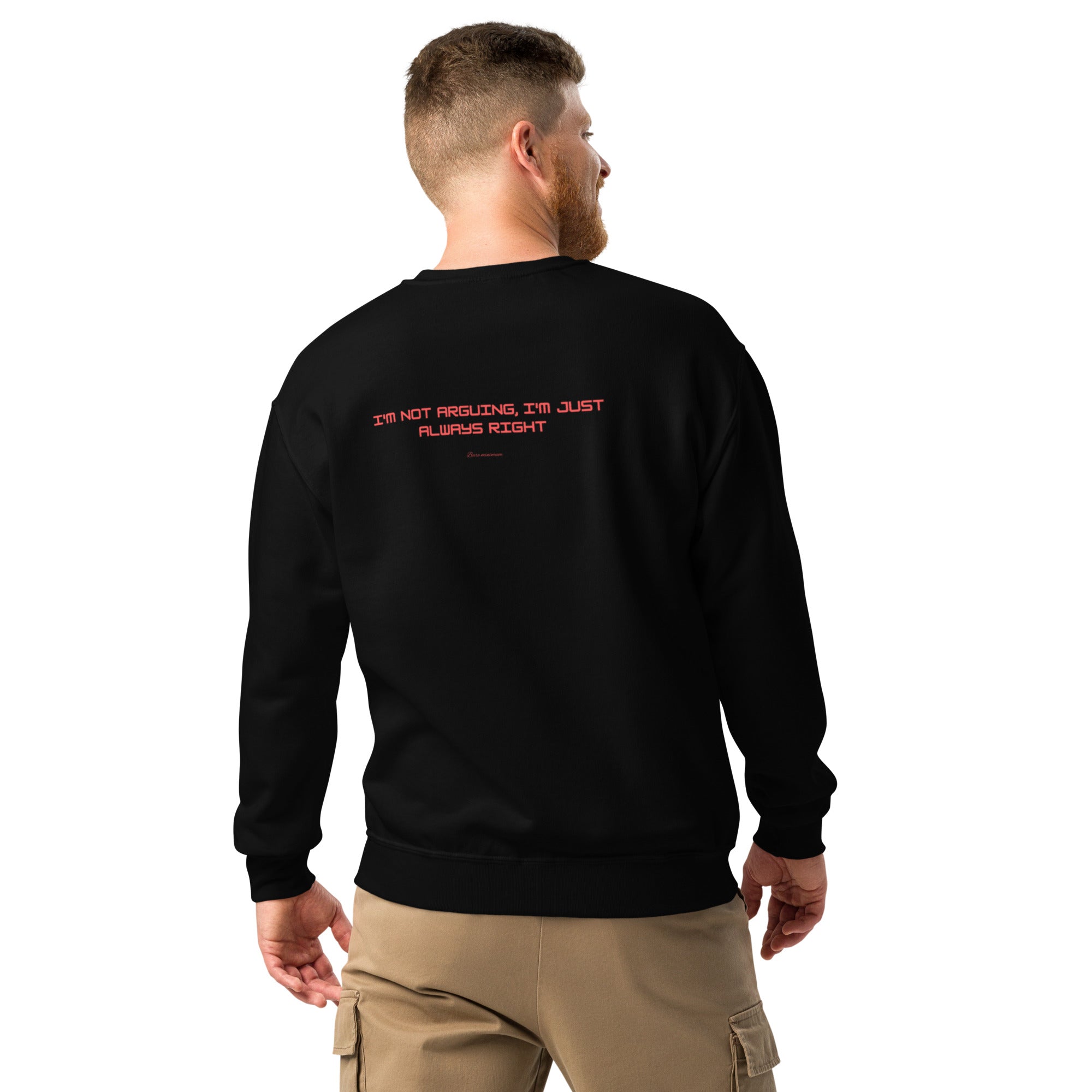 Man wearing a black sweatshirt with red text on the back, standing against a white background