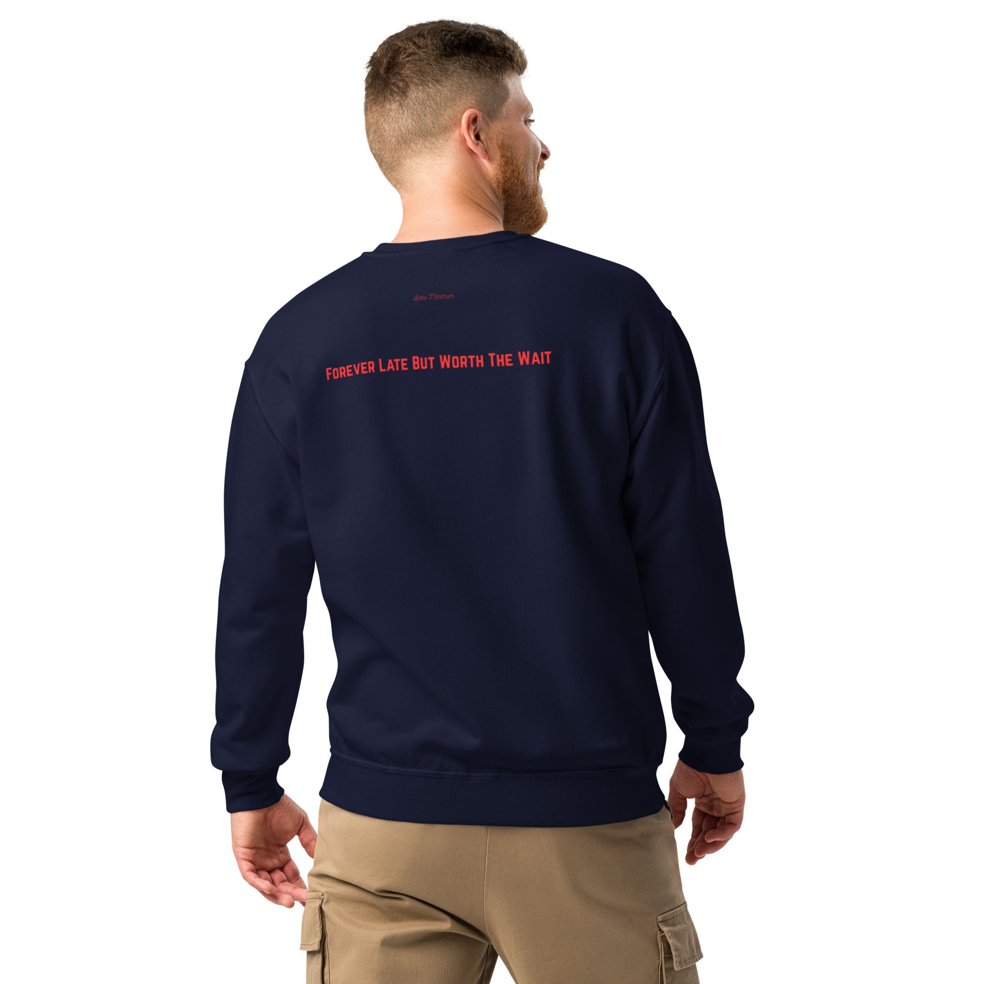 Man wearing a navy sweatshirt with red text on the back, standing against a white background