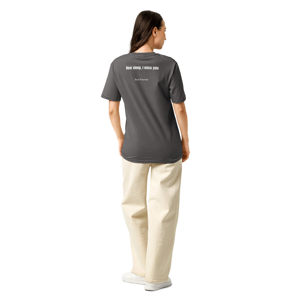 Person wearing a black t-shirt with a design on the back, standing against a white background
