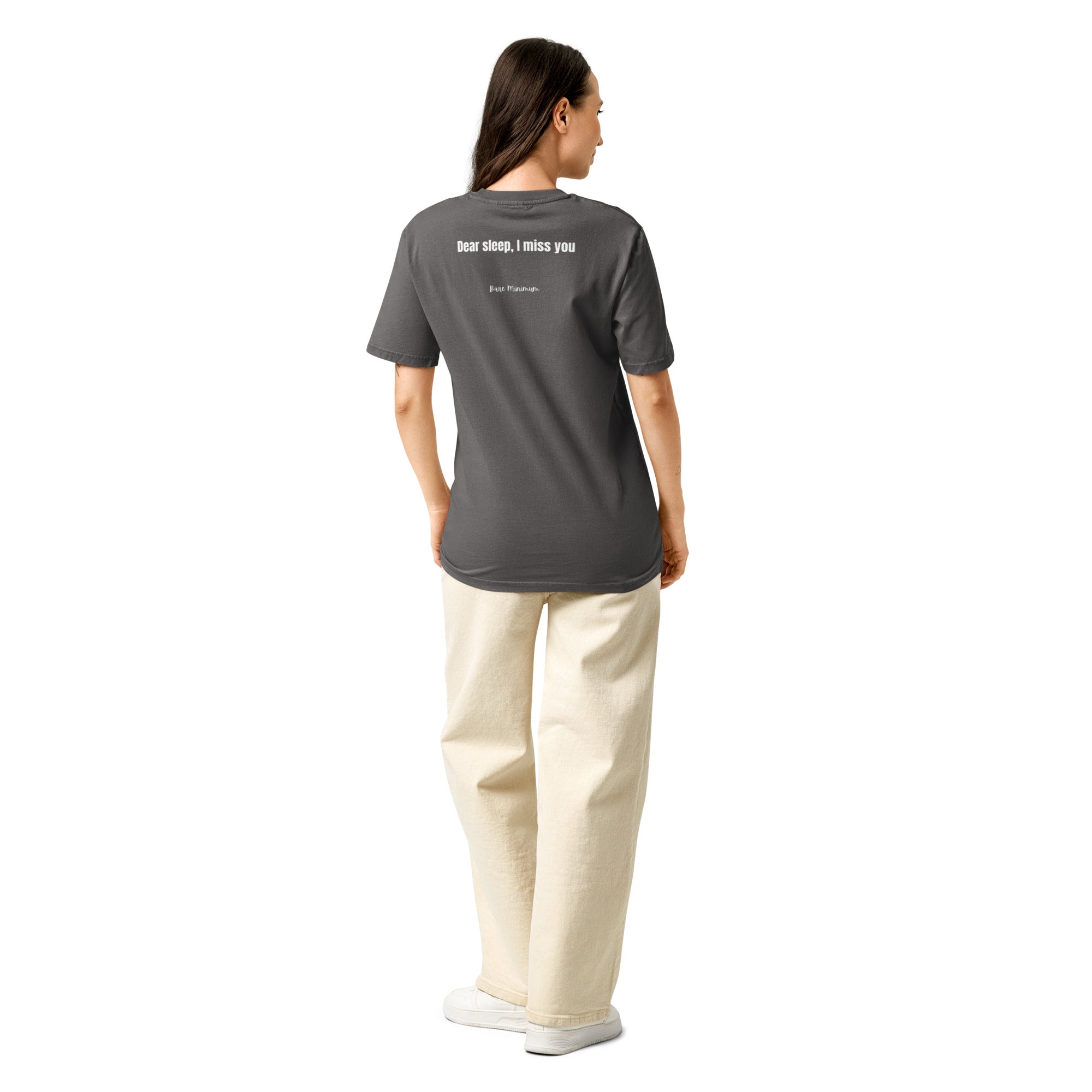 Person wearing a black t-shirt with a design on the back, standing against a white background