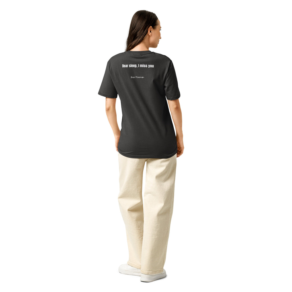 Person wearing a black t-shirt and beige pants on a white background