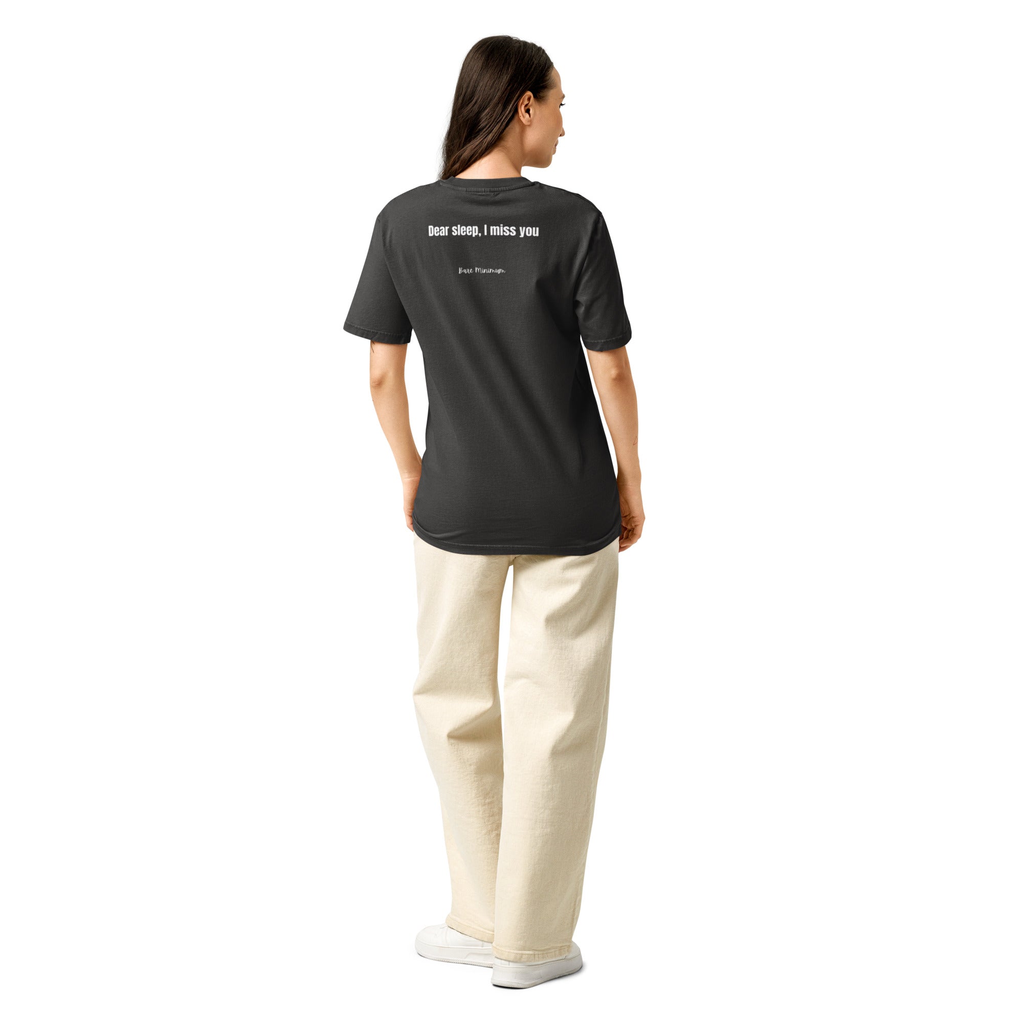 Person wearing a black t-shirt and beige pants on a white background