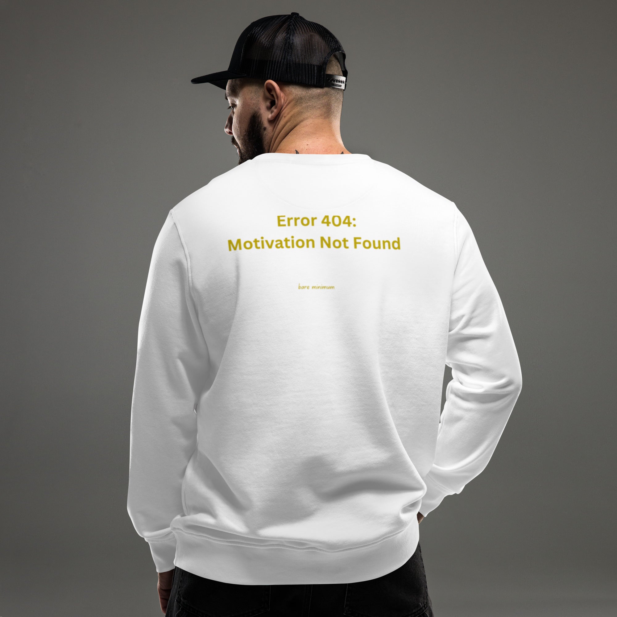 Person wearing a white sweatshirt with 'Eat More Breakfast' text on the back against a gray background